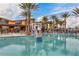 A community pool with seating, basketball hoop, and palm trees at 9821 E Supernova Dr, Mesa, AZ 85212