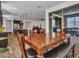An open-concept dining area with a wooden table and chairs next to the kitchen with a view of the patio at 9821 E Supernova Dr, Mesa, AZ 85212