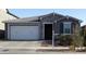 Charming single-Gathering home featuring a stone facade, a two-car garage, and well-maintained landscaping at 9821 E Supernova Dr, Mesa, AZ 85212
