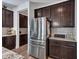 Modern kitchen showcasing stainless steel refrigerator and dark cabinetry, complemented by granite countertops and tiled backsplash at 9821 E Supernova Dr, Mesa, AZ 85212