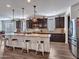Expansive kitchen with dark cabinets, granite countertops, a large island with seating, and stainless steel appliances at 9821 E Supernova Dr, Mesa, AZ 85212
