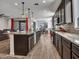 Open-concept kitchen featuring a spacious island, stainless steel appliances, and seamless flow to the living and dining areas at 9821 E Supernova Dr, Mesa, AZ 85212