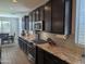 Modern kitchen with stainless steel appliances, granite countertops, and dark wood cabinetry at 9821 E Supernova Dr, Mesa, AZ 85212