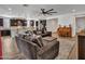 A spacious living room with a large sofa and open access to the kitchen and dining areas at 9821 E Supernova Dr, Mesa, AZ 85212