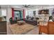 A spacious living room with a large sofa and open access to the kitchen area at 9821 E Supernova Dr, Mesa, AZ 85212