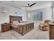 A serene main bedroom with a ceiling fan, natural light, and comfortable furnishings at 9821 E Supernova Dr, Mesa, AZ 85212