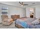 This bedroom offers a comfortable chair and an inviting ambiance, perfect for relaxation at 9821 E Supernova Dr, Mesa, AZ 85212