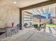 Covered patio with stylish outdoor seating and a cozy fire pit for relaxed entertaining at 9821 E Supernova Dr, Mesa, AZ 85212