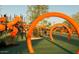 Modern playground with orange slides and climbing structures, perfect for Gathering fun at 9821 E Supernova Dr, Mesa, AZ 85212