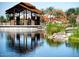 Community pond with walking path and decorative metal art features at 9821 E Supernova Dr, Mesa, AZ 85212
