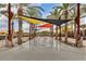 Inviting community splash pad with colorful shade sails and palm trees at 9821 E Supernova Dr, Mesa, AZ 85212