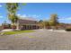 Expansive backyard with a gravel landscape, a pool, a lush green turf area, and ample space for recreation at 1012 E Rosebud Dr, San Tan Valley, AZ 85143