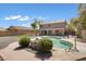 Large backyard with a pool, gravel landscaping, and a covered patio perfect for outdoor gatherings at 1012 E Rosebud Dr, San Tan Valley, AZ 85143