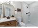 Bathroom with wood vanity, brushed bronze hardware, commode and white shower with white subway tiles at 1012 E Rosebud Dr, San Tan Valley, AZ 85143