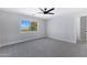 Bright bedroom featuring a ceiling fan, window, and neutral color palette at 1012 E Rosebud Dr, San Tan Valley, AZ 85143