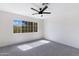 Bright bedroom featuring a ceiling fan, a window, and neutral color palette at 1012 E Rosebud Dr, San Tan Valley, AZ 85143