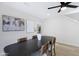 Stylish dining room with decorative artwork and a black ceiling fan over a dark wood table at 1012 E Rosebud Dr, San Tan Valley, AZ 85143