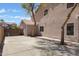 Side view of a home with a large concrete area, a side door, and mature trees providing shade at 1012 E Rosebud Dr, San Tan Valley, AZ 85143