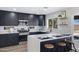 This is a kitchen with a quartz countertop island, stainless steel appliances, and black cabinets at 1012 E Rosebud Dr, San Tan Valley, AZ 85143