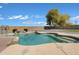 A beautiful backyard pool with a rock waterfall feature and low maintenance landscaping at 1012 E Rosebud Dr, San Tan Valley, AZ 85143