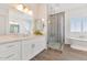 Bathroom with a freestanding tub, tiled shower, double sink vanity, and bright natural light at 10147 W Camino De Oro --, Peoria, AZ 85383