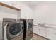 The well-appointed laundry room includes a sink, storage, and modern appliances at 10147 W Camino De Oro --, Peoria, AZ 85383