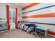 Bedroom with a striped accent wall, desk, and white furniture at 10249 W Redbird Rd, Peoria, AZ 85383