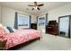 Comfortable bedroom featuring carpeted floors, neutral walls, and a ceiling fan for added comfort and air circulation at 10249 W Redbird Rd, Peoria, AZ 85383