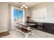 Bright dining area with a wooden table, bench seating, and large windows offering plenty of natural light at 10249 W Redbird Rd, Peoria, AZ 85383