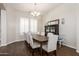 Elegant dining room with hardwood floors, a classic chandelier, and comfortable seating for a formal dining experience at 10249 W Redbird Rd, Peoria, AZ 85383