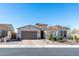 Charming single-story home with a well-manicured front yard and a two-car garage on a sunny day at 10249 W Redbird Rd, Peoria, AZ 85383