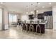 Modern kitchen featuring a large island with seating, stainless steel appliances, and elegant pendant lighting at 10249 W Redbird Rd, Peoria, AZ 85383