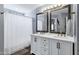 Well-lit bathroom featuring a double vanity with framed mirrors and shower with curtains at 10256 N 12Th Pl # 3, Phoenix, AZ 85020