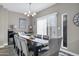 Inviting dining room featuring a long wooden table, elegant chairs, a large window, and modern lighting at 10256 N 12Th Pl # 3, Phoenix, AZ 85020