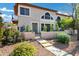 Inviting two-story home with lush landscaping and decorative wall leading to private front entrance at 10256 N 12Th Pl # 3, Phoenix, AZ 85020