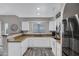 U-shaped kitchen featuring white cabinetry, stainless steel appliances, a breakfast bar, and modern fixtures at 10256 N 12Th Pl # 3, Phoenix, AZ 85020