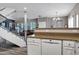 Open kitchen area featuring white cabinets, stainless steel appliances, a breakfast bar, and connection to living spaces at 10256 N 12Th Pl # 3, Phoenix, AZ 85020