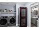 Well-organized laundry room featuring a wine cooler, washer, dryer, and ample storage at 10256 N 12Th Pl # 3, Phoenix, AZ 85020