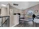 Upstairs loft with unique arch window providing natural light, a workspace, and railing overlooking the home at 10256 N 12Th Pl # 3, Phoenix, AZ 85020