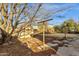 Backyard featuring a shed, mature trees, and a concrete patio area at 104 S Doran --, Mesa, AZ 85204