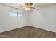 Unfurnished bedroom featuring neutral walls, vinyl floors, and a ceiling fan at 104 S Doran --, Mesa, AZ 85204