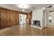 Traditional living room with a stone fireplace and wood-paneled walls at 104 S Doran --, Mesa, AZ 85204