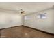 Unfurnished living room featuring neutral walls, multiple windows, and a ceiling fan at 104 S Doran --, Mesa, AZ 85204