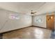 Unfurnished living room featuring neutral walls, multiple windows, and a ceiling fan at 104 S Doran --, Mesa, AZ 85204