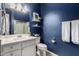 Stylish bathroom features a blue accent wall, white vanity, and convenient towel racks at 10532 E Palladium Dr, Mesa, AZ 85212