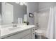 Well-lit bathroom featuring a clean white vanity, a large mirror, and a shower-tub combination at 10532 E Palladium Dr, Mesa, AZ 85212