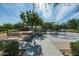 Picturesque community park with splash pad, seating, walking paths, and mature trees on a sunny day at 10532 E Palladium Dr, Mesa, AZ 85212