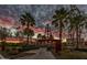 Landscaped community park with kinetic point, palm trees, and walking paths at sunset at 10532 E Palladium Dr, Mesa, AZ 85212