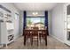 Bright dining area with dark wood table, stylish decor, and large window providing pleasant views at 10532 E Palladium Dr, Mesa, AZ 85212