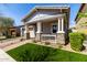 Inviting single-story home with stone accents, charming front porch, manicured lawn and beautiful landscaping at 10532 E Palladium Dr, Mesa, AZ 85212